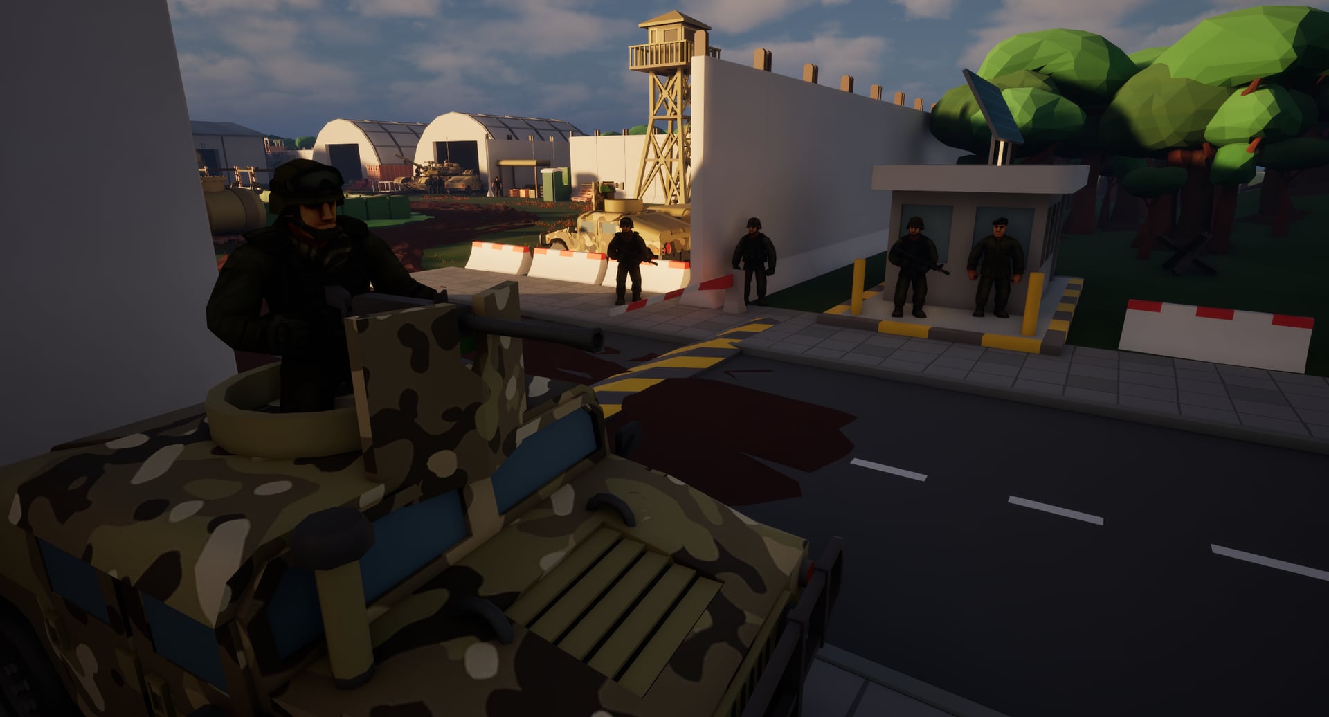 The gate at Fort Crossroads — a camouflaged gun truck, guards and a checkpoint